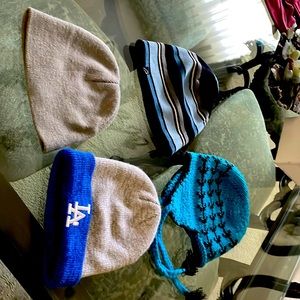Four excellent condition hats. When is gray and says LA one of them is hand knit
